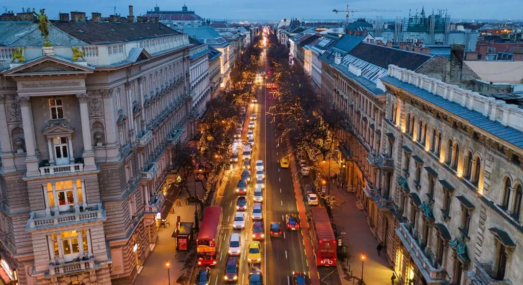 An aerial view of a bustling Budapest street, lined with historic, ornate buildings. Photography by Krisztián Bódis