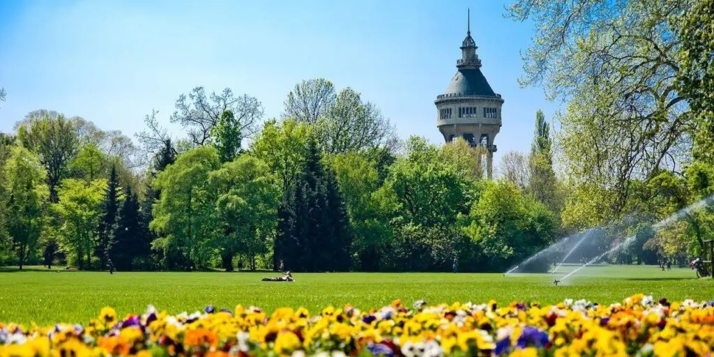 Big clearing with colorful flowers on Margaret Island, Budapest, and the Water tower in the background