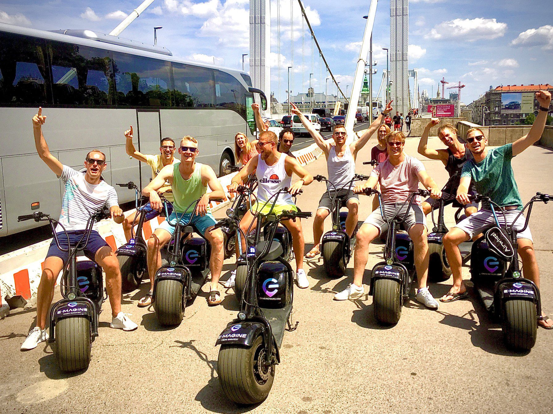 A group of people sitting on E-scooters at the Elizabeth bridge in Budapest