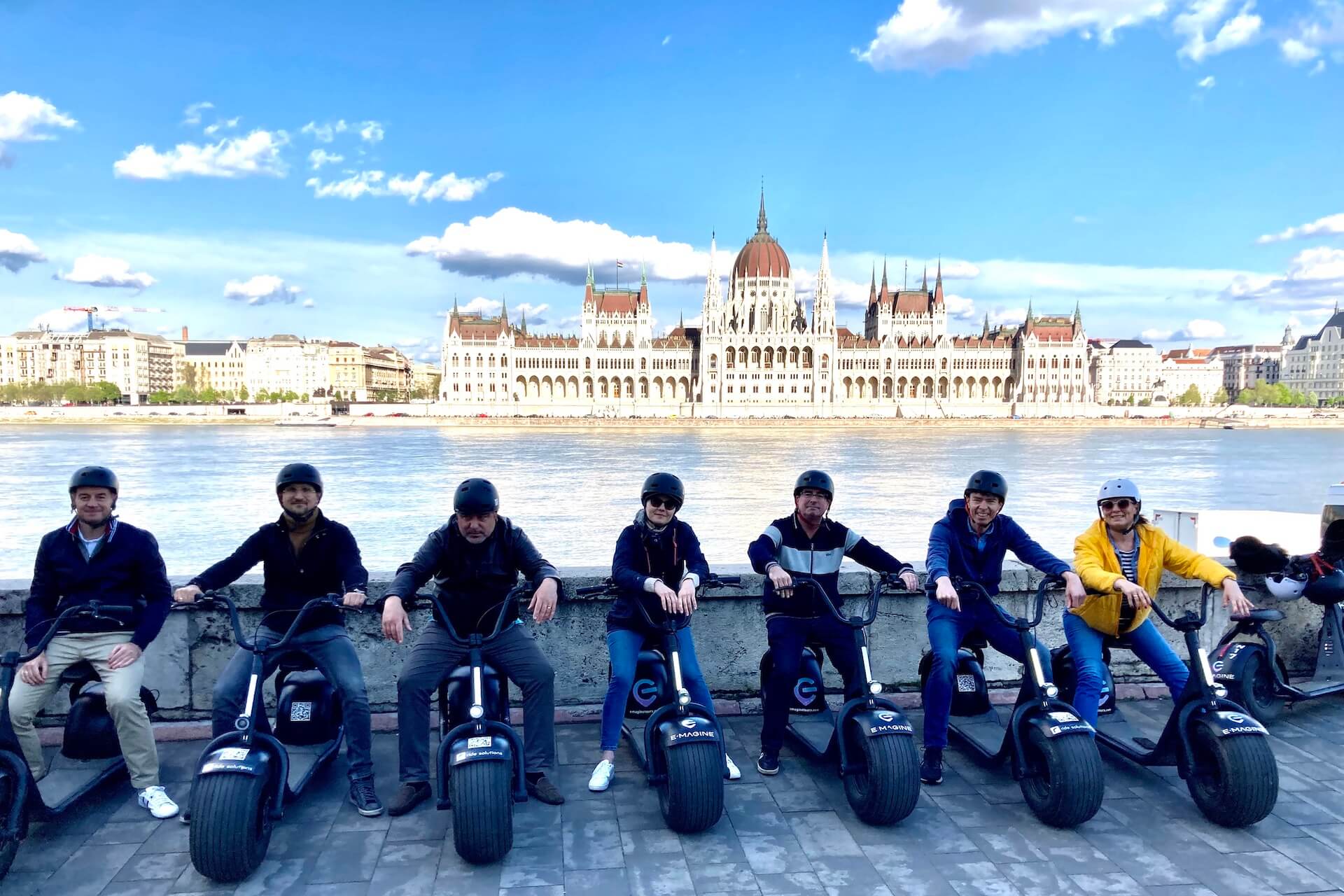 Fairy Garden tour riders on the Buda side of the Danube with the Parliament in the background