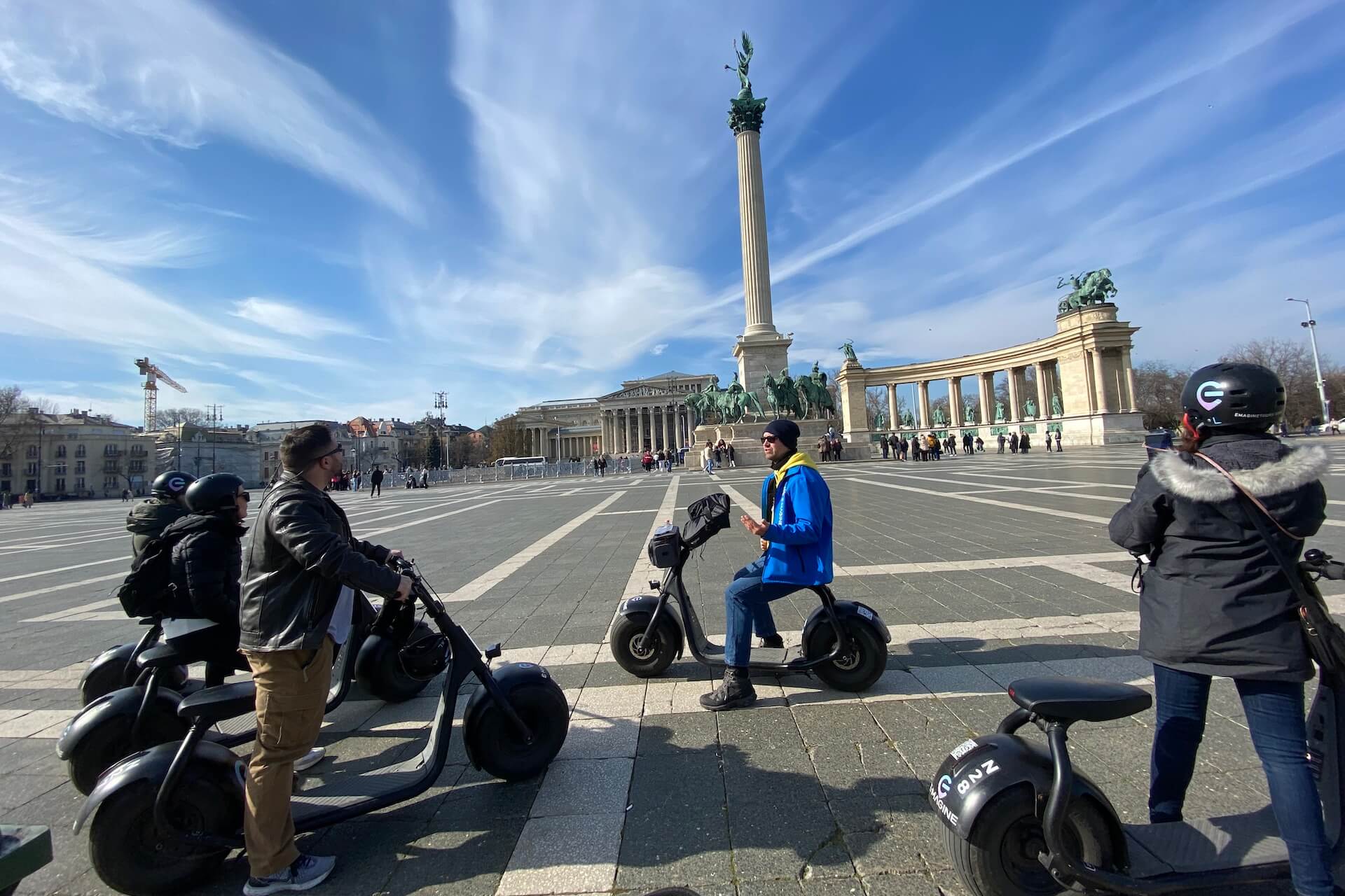 A group of people listening to their guide at Heroes' Square