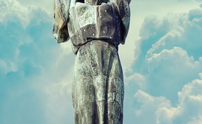 A tall bronze statue of a woman holding a large palm leaf above her head stands on a stone pedestal, set against a partly cloudy sky—an iconic sight often admired during a Budapest Citadel tour.